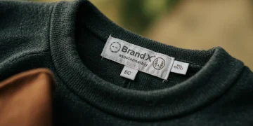 Brand X sustainable clothing line tag, eco-friendly fabric detail