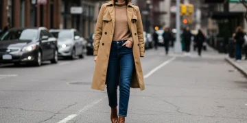 Woman in classic trench coat and leather handbag, embodying timeless style