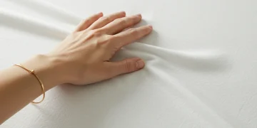 Close-up of high-quality white cotton fabric with subtle texture